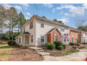 Charming townhome with a landscaped front yard, brick accent, and inviting entrance at 3610 Melrose Cottage Dr, Matthews, NC 28105