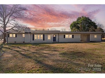 Charming one-story home featuring a landscaped yard and inviting facade under a colorful sunset at 41 Fleetwood Sw Dr # 44, Concord, NC 28027