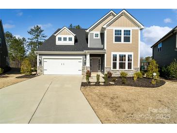 Inviting two-story home featuring a two-car garage and well-maintained landscaping at 416 Clemson Tree Ln, Lake Wylie, SC 29710