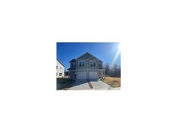New two-story townhouse with gray siding, attached garage, and freshly poured concrete driveway at 620 Smith St # B, Mooresville, NC 28115