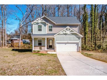 Charming two-story home with a manicured lawn and attached one car garage at 955 General Hoke Dr, Lincolnton, NC 28092