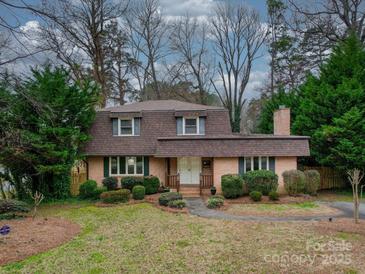 Charming brick home with a well-manicured lawn and mature landscaping at 1200 Berkshire Dr, Kannapolis, NC 28081