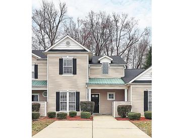 Charming townhouse featuring a covered entrance, well-kept landscaping, and classic architectural details at 1765 Holliford Ct, Charlotte, NC 28215