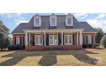 Charming brick home featuring a welcoming front porch with columns and dormer windows at 2968 Robinwood Rd, Gastonia, NC 28054