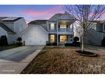 Charming two-story home featuring a balcony, attached garage, and well-manicured lawn in a cozy residential neighborhood at 3726 Ernie Dr, Charlotte, NC 28269