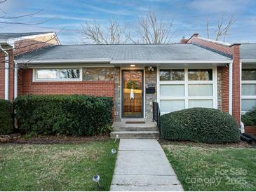 Charming home with stone and brick facade, manicured bushes, and inviting walkway at 4310 Randolph Rd, Charlotte, NC 28211