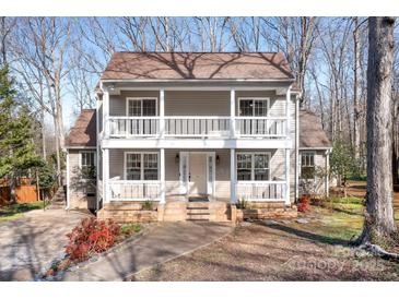 Charming two-story home featuring double balconies, a well-maintained yard, and inviting curb appeal at 11121 Timber Hill Ct, Charlotte, NC 28226