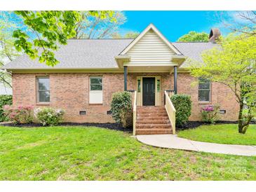 Charming brick home featuring a welcoming front porch and well-maintained landscaping at 2041 Jefferson Ave, Gastonia, NC 28056