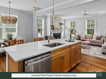 Open concept kitchen with island, stainless steel appliances, and seamless access to the dining and living areas at 274 Gilead Rd, Huntersville, NC 28078