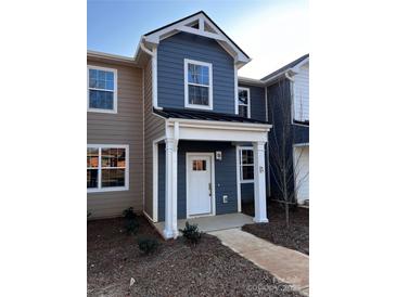 Charming two-story townhome with covered entry, manicured landscaping, and appealing exterior finishes at 330 Malvern Sw Ave # B, Concord, NC 28025
