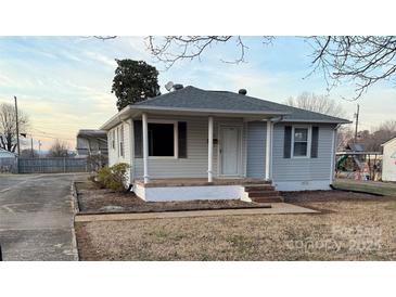 Charming single-story home featuring a covered porch and vinyl siding at 3412 1St Avenue Nw Cir, Hickory, NC 28601