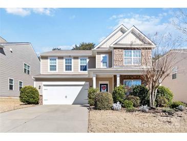 Charming two-story home with a well-manicured lawn and attached two-car garage at 4462 Haddington Dr, Fort Mill, SC 29707