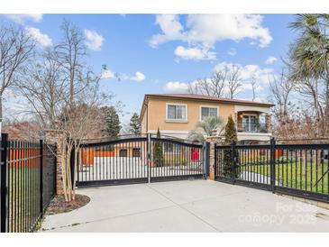 Stately home with a secure gated entrance and a well-manicured lawn at 8104 Stem Ct, Charlotte, NC 28227