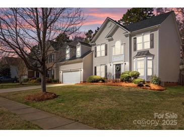 Charming two-story home featuring a well-manicured lawn and a classic architectural design at 910 Elrond Nw Dr, Charlotte, NC 28269