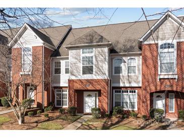 Townhome exterior with brick facade, multiple windows, and well-maintained landscaping at 1127 Central Park Cir, Davidson, NC 28036