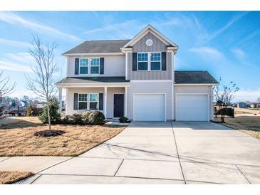 Charming two-story home with a three-car garage and manicured front lawn at 140 Jana Dr, Statesville, NC 28677