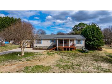 Charming home featuring a quaint front porch, stone accents, and a well-maintained lawn at 1818 Valley Springs Se Dr, Conover, NC 28613