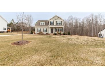 Charming two-story home featuring a welcoming front porch and a well-maintained yard on a spacious lot at 5051 Oxbow Run Ln, York, SC 29710