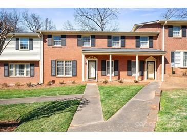 Charming brick townhome featuring black shutters and a well-manicured lawn at 623 S New Hope Rd # 4, Gastonia, NC 28054