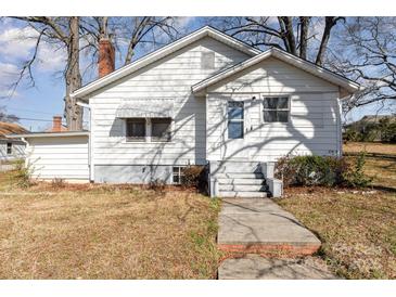 Charming single-story home featuring a classic design, complemented by a walkway leading to the front door at 106 W 16Th St, Kannapolis, NC 28081