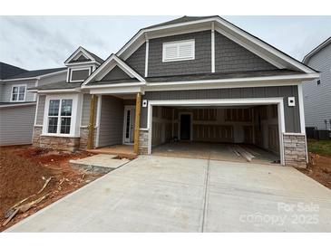 Charming new construction home with stone accents, gray siding, and a spacious two-car garage at 2210 Camber Dr # Cwo0075, Gastonia, NC 28054