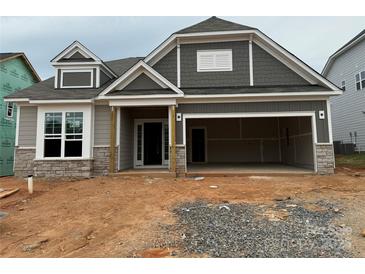 New construction exterior with gray siding, stone accents, and attached two-car garage at 2210 Camber Dr # Cwo0075, Gastonia, NC 28054