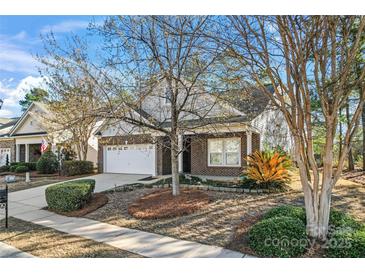 Charming brick home featuring a well-manicured lawn and an attached two-car garage at 2439 Bergamot St, Fort Mill, SC 29708