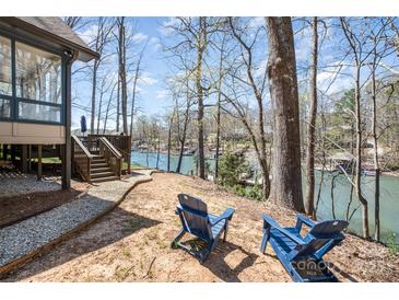 Picturesque backyard with stunning lake views and Adirondack chairs, perfect for relaxation at 353 Whippoorwill Rd, Mooresville, NC 28117