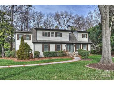 Charming two-story home featuring a landscaped front yard and brick walkway at 830 Jefferson Dr, Charlotte, NC 28270