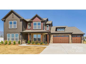 Stunning two-story home featuring a mix of stone and siding, complemented by a spacious three-car garage at 1030 Rolling Meadows Dr # Rm13, Mooresville, NC 28115