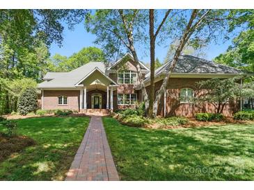 Charming brick home with a welcoming front porch and beautifully landscaped yard at 12702 Overlook Mountain Dr, Charlotte, NC 28216