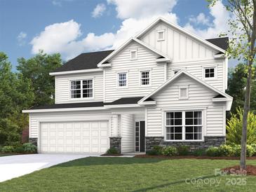 Charming two-story home boasts a manicured lawn, attached two car garage, and classic white siding at 2216 Camber Dr # Cwo0074, Gastonia, NC 28054