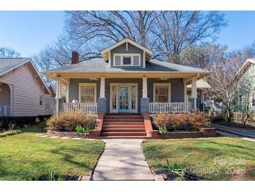 Charming home featuring a brick front porch and stairs, complemented by a well-manicured lawn and classic architectural details at 316 S Summit Ave, Charlotte, NC 28208