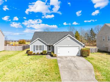 Charming single-story home with a well-manicured lawn and attached two-car garage at 414 Glencroft Dr, Wingate, NC 28174