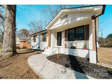 Charming, freshly painted home with updated landscaping, inviting curb appeal, and a new walkway at 7231 Lockmont Dr, Charlotte, NC 28212