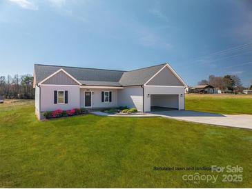 New construction featuring an inviting open garage, lush simulated lawn, and a charming exterior at 1282 Beal Rd, Lincolnton, NC 28092