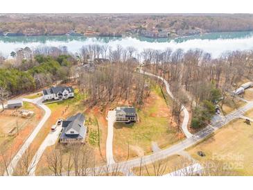 A waterfront property with luxurious houses overlooking a beautiful body of water in a serene environment at 247 Reese Wilson Rd, Belmont, NC 28012