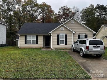 Charming home featuring a well-maintained lawn and a private driveway at 5702 Burning Ridge Dr, Monroe, NC 28110