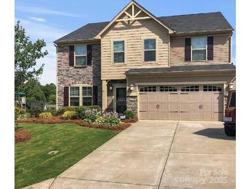 Charming two-story home with a combination of brick and siding and a well-manicured lawn at 6112 Canyon Trl, Denver, NC 28037