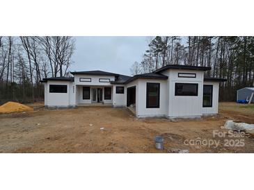 New modern home with white siding, black trim, and a contemporary design at 6855 Union Rd, Gastonia, NC 28056