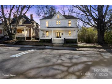 Charming two-story home with a inviting front porch and classic architectural details at 85 Grove Nw Ave, Concord, NC 28025