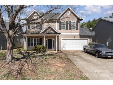 Charming two-story home boasts a two-car garage, welcoming front porch, and manicured landscaping at 757 Jones Branch Rd, Fort Mill, SC 29715