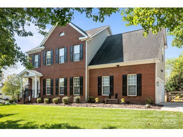 Beautiful two-story brick home with black shutters and a well-manicured lawn at 150 Harbor Cove Ln, Mooresville, NC 28117