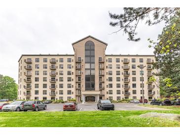 Expansive exterior view of condo building featuring a brick facade, multiple stories, and convenient parking at 211 Heritage Blvd # 108, Fort Mill, SC 29715
