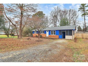 Charming home with a blue exterior, red brick, screened in porch, and spacious front yard at 333 S Eastway Dr, Troutman, NC 28166