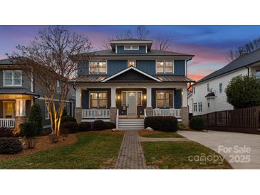 Charming two-story home featuring a welcoming porch with white columns and a landscaped front yard at 448 Iverson Way, Charlotte, NC 28203