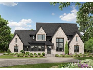 Charming brick home featuring a black roof, black trim, and a beautifully landscaped front yard at 620 Deodar Cedar Dr, Weddington, NC 28104