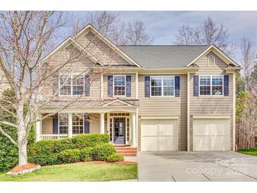Beautiful two-story home featuring a well-manicured lawn, attached two-car garage and charming front porch area at 6458 Chadwell Ct # 30, Indian Land, SC 29707