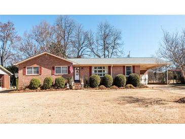 Charming brick home with a covered carport and landscaped front yard at 662 University Dr, Rock Hill, SC 29730