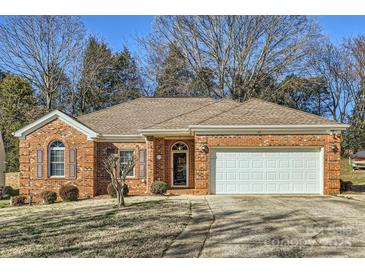 Charming brick home with a well-manicured lawn and attached two-car garage at 127 Lakewood Circle Dr, Mooresville, NC 28117